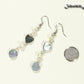 Long Grey Seashell and Freshwater Pearl Earrings beside a dime.