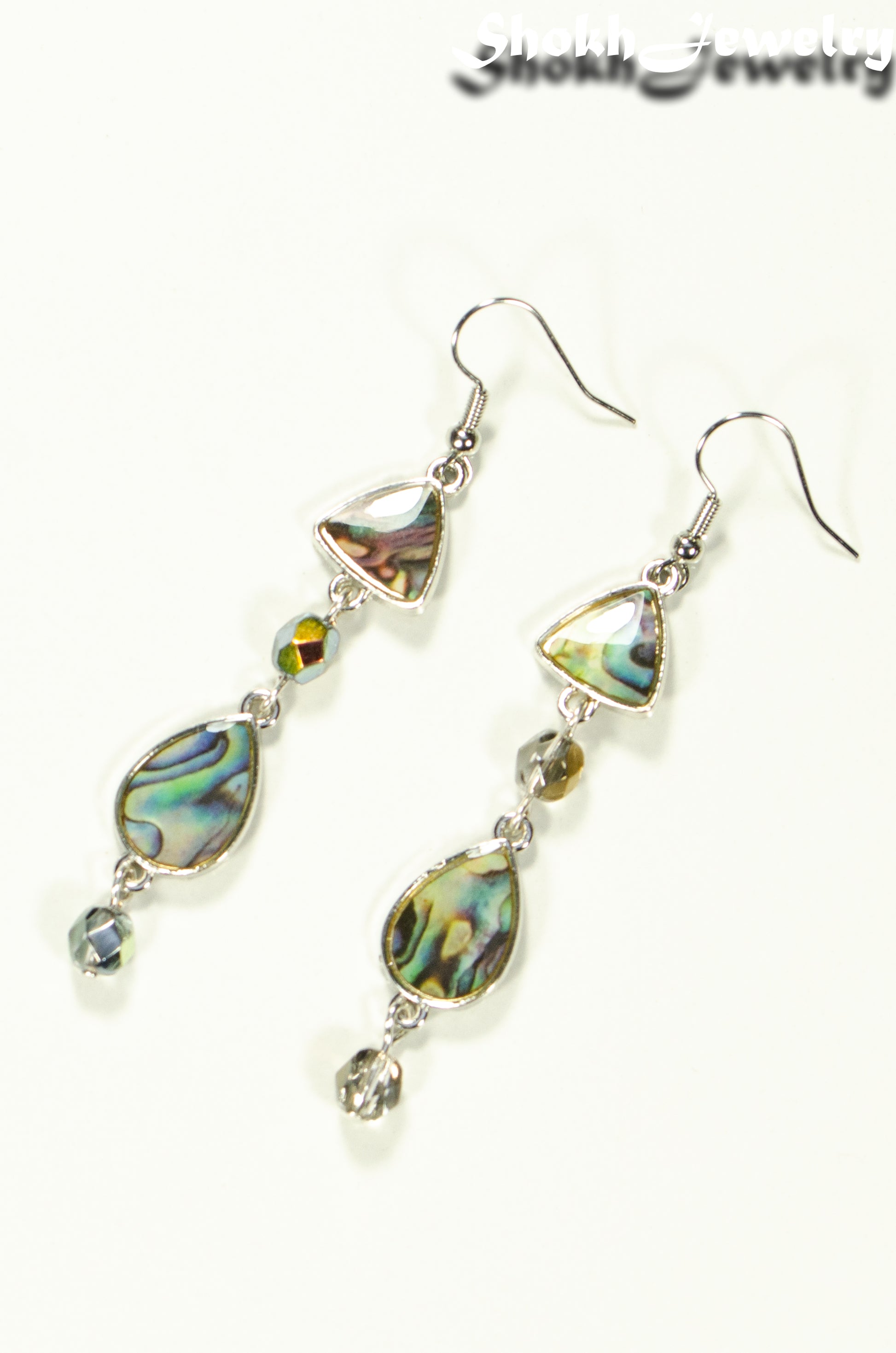 Top view of Long Abalone Shell and Glass Crystal Earrings.