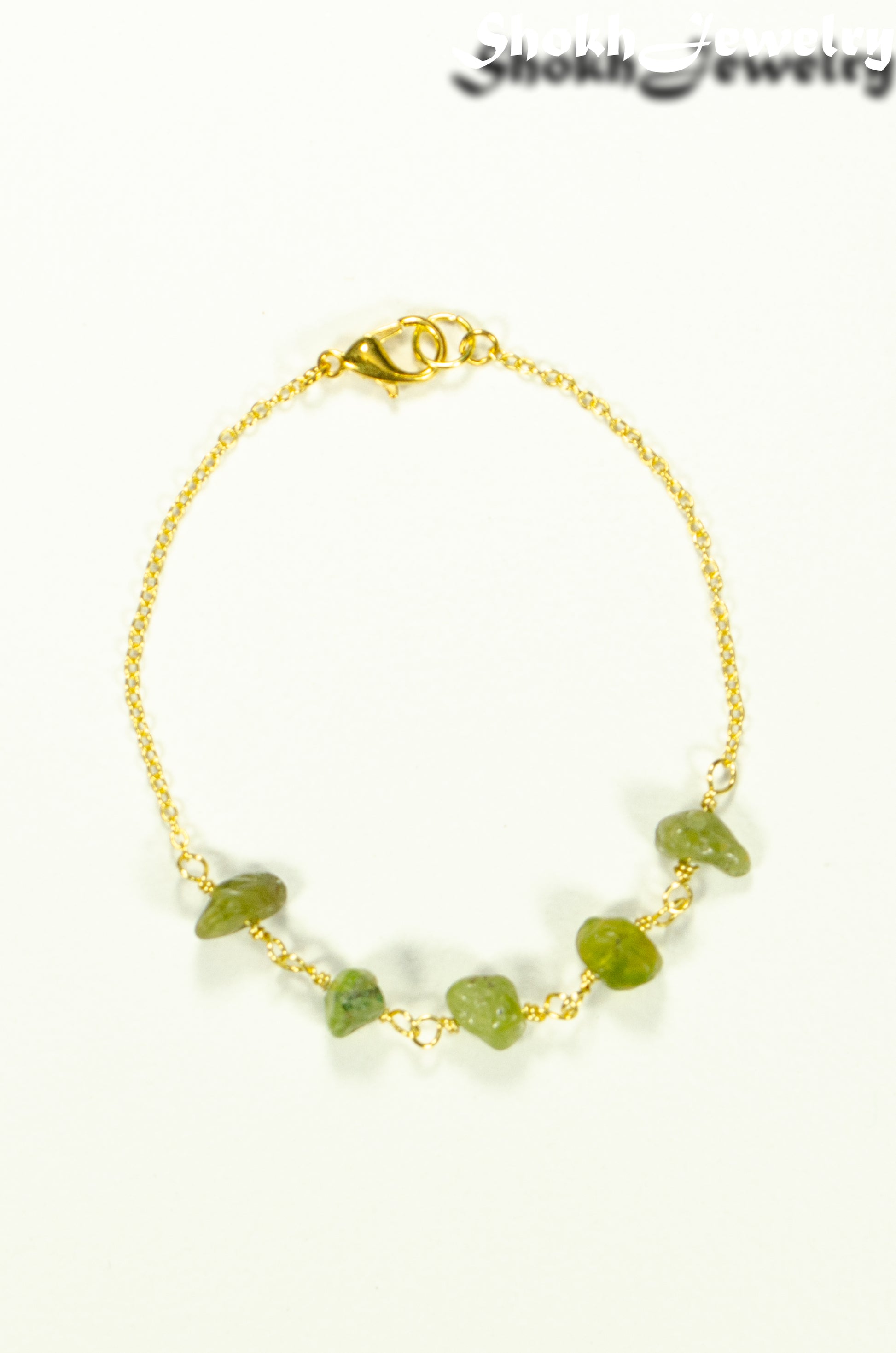 Top view of Peridot Crystal Chip and Gold Plated Chain Bracelet.