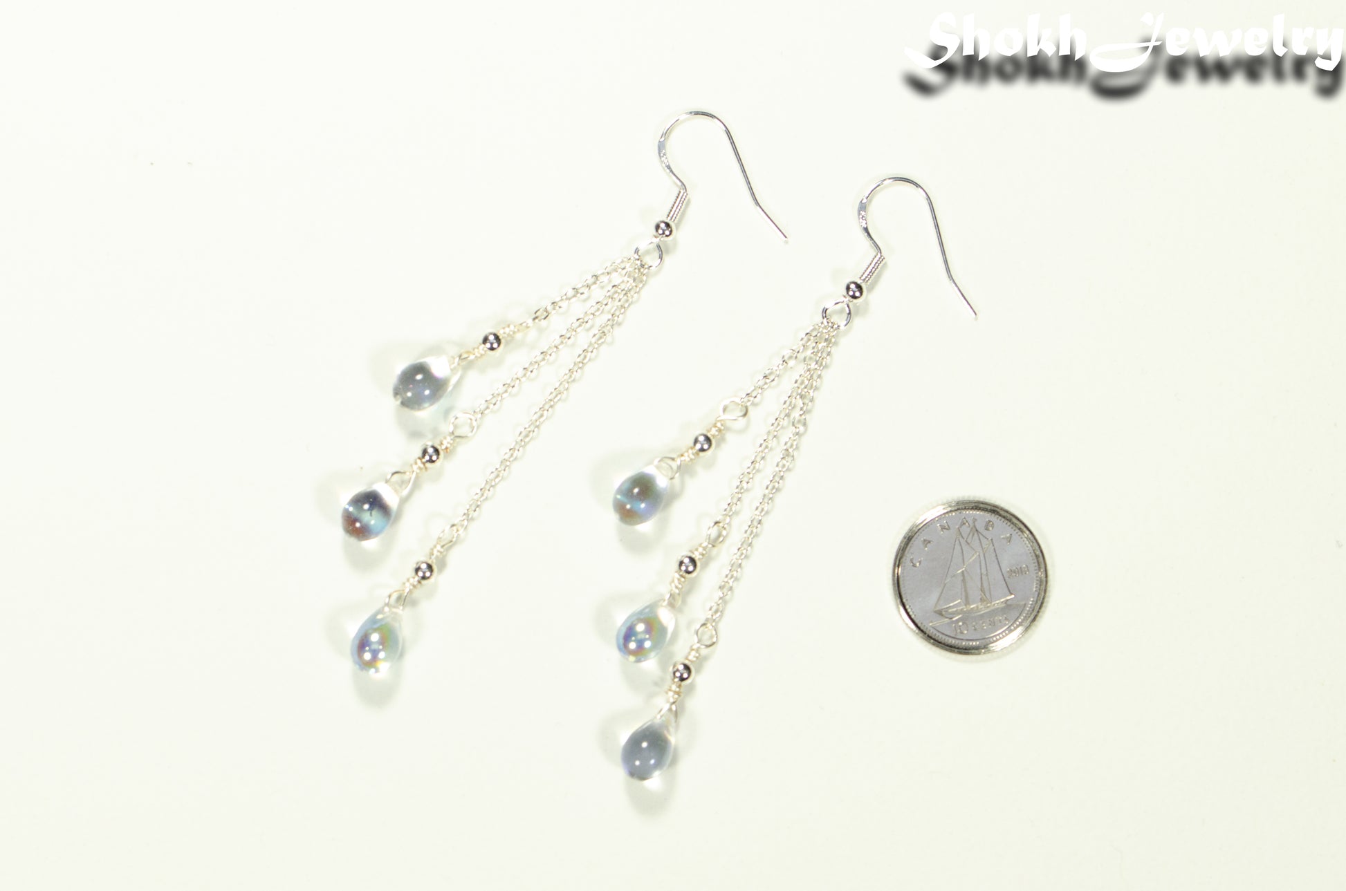 Long Silver Plated Chain and Czech Teardrop Crystal Earrings beside a dime.