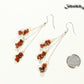 Long Silver Plated Chain and Red Jasper Chip Earrings beside a dime.