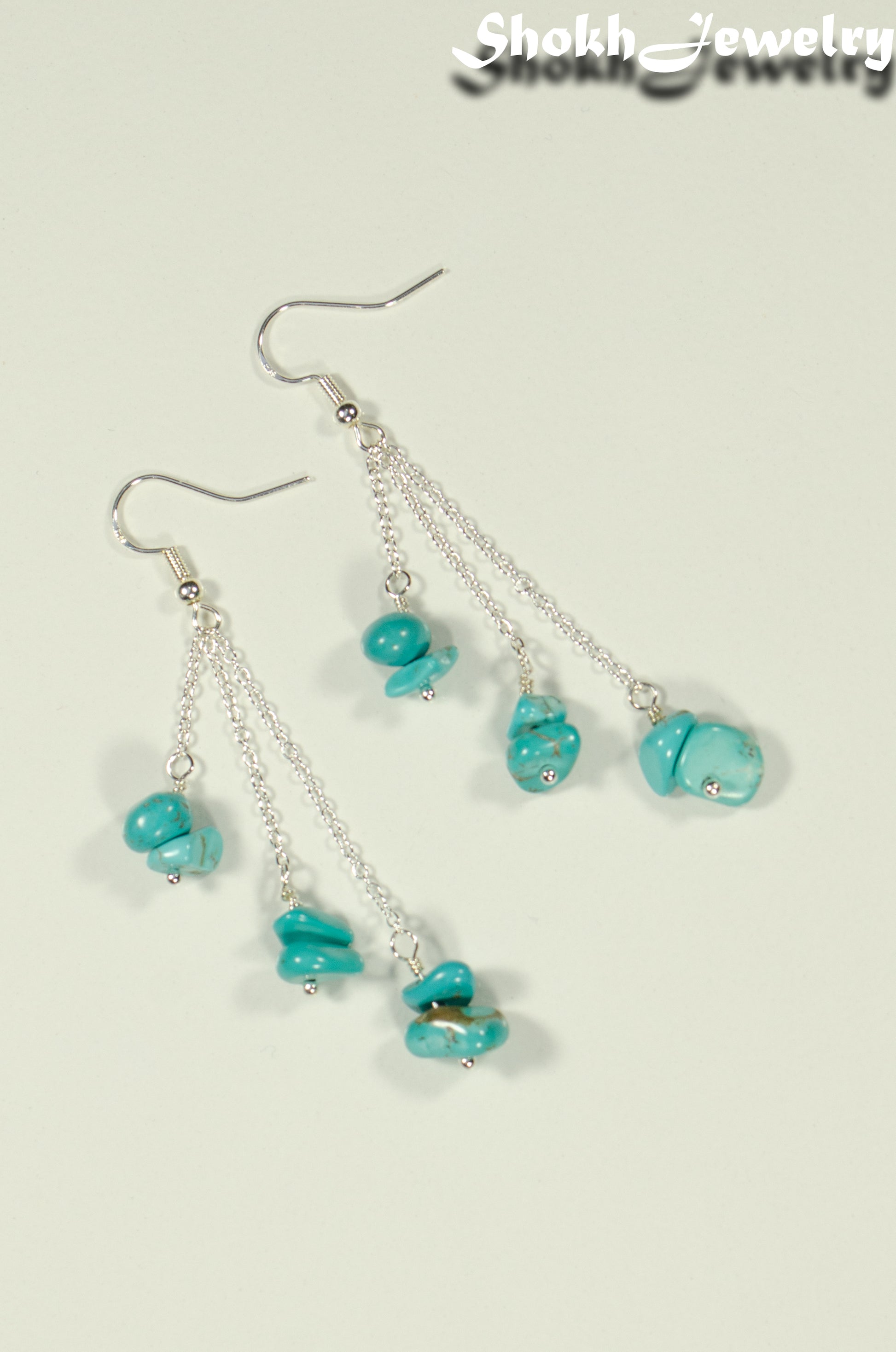 Top view of Long Silver Plated Chain and Turquoise Crystal Chip Earrings.