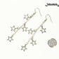 Stainless steel chain and 4 star earrings beside a dime.