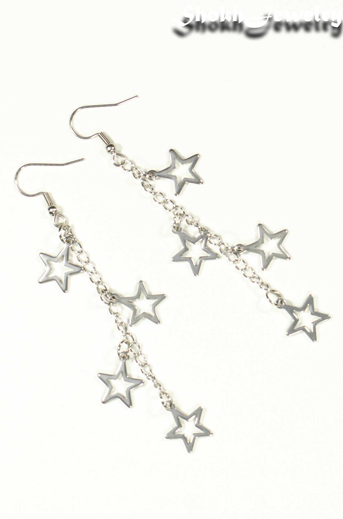 Top view of Stainless steel chain and 4 star earrings.