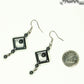 Long Black Hematite Geometric Earrings beside a dime.