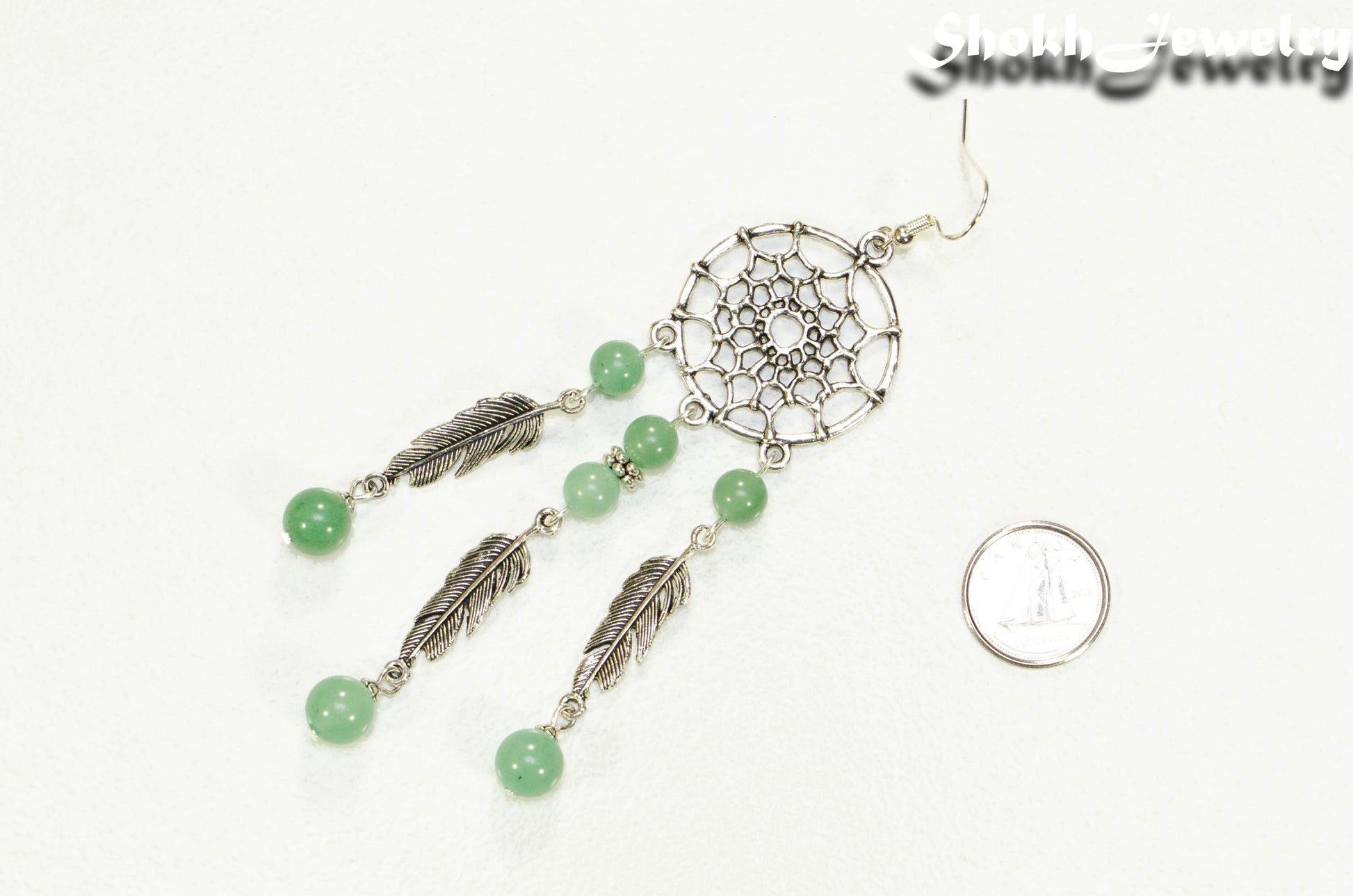 Extra Long Green Aventurine Dream Catcher Earring beside a dime.