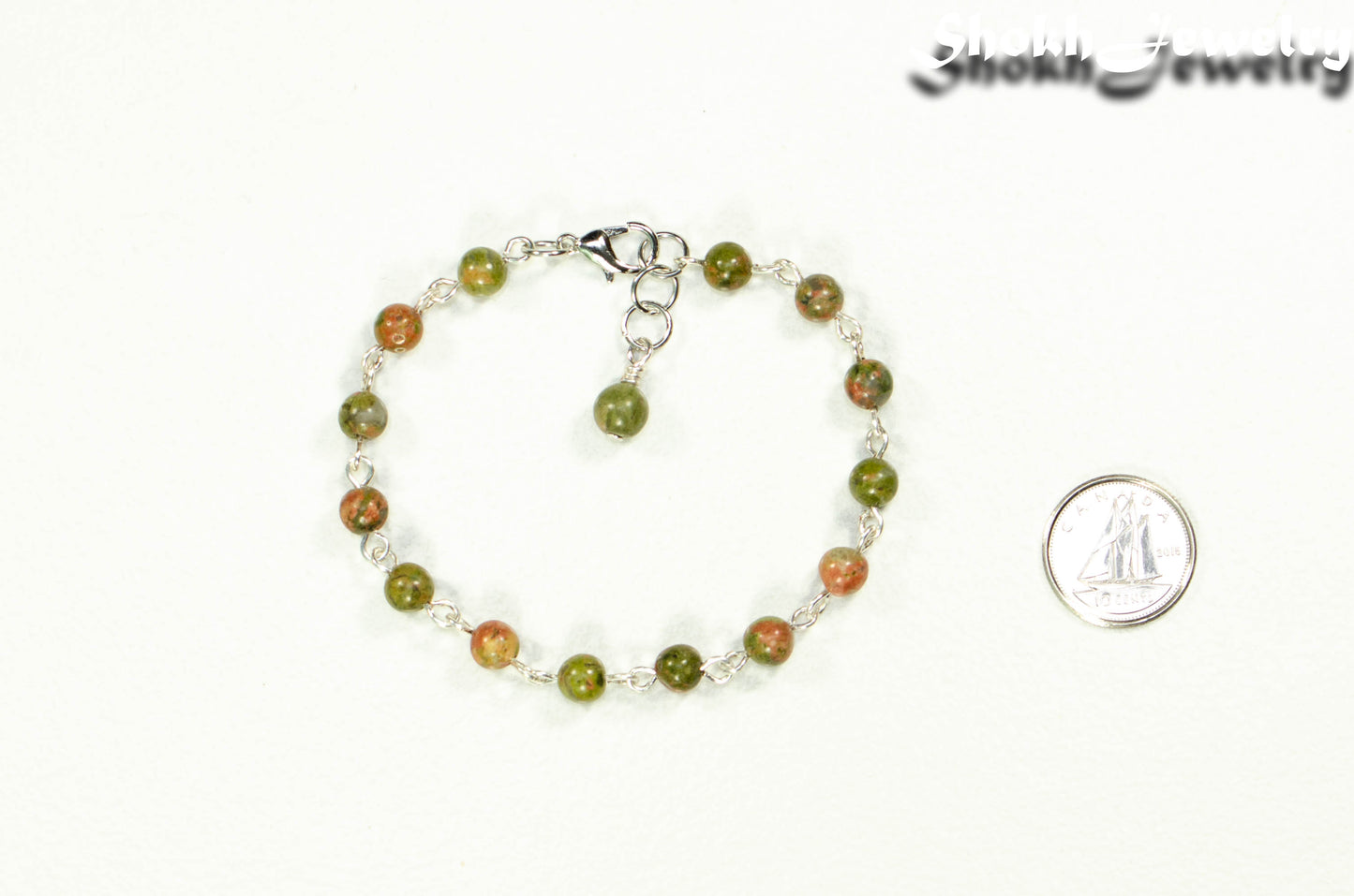 6mm Unakite Jasper Link Bracelet beside a dime.