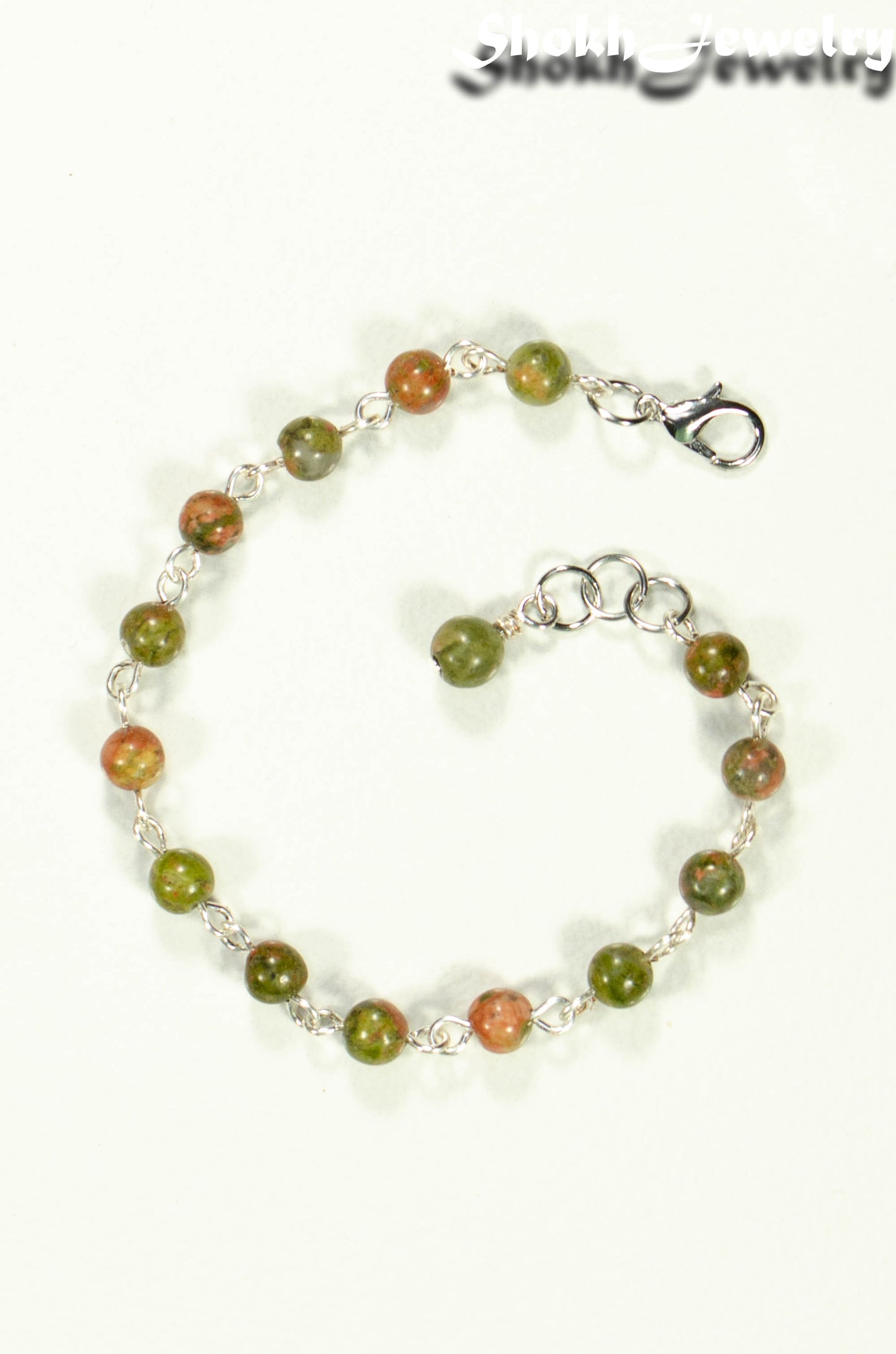 Top view of 6mm Unakite Jasper Link Bracelet with clasp.