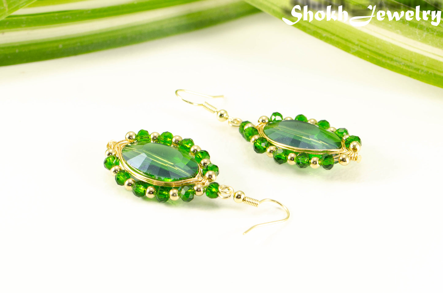 Oval Green Glass Crystal Wire Wrapped Earrings with gold tone ear wires.