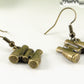 Close up of Antique Bronze Binocular Charm Earrings.