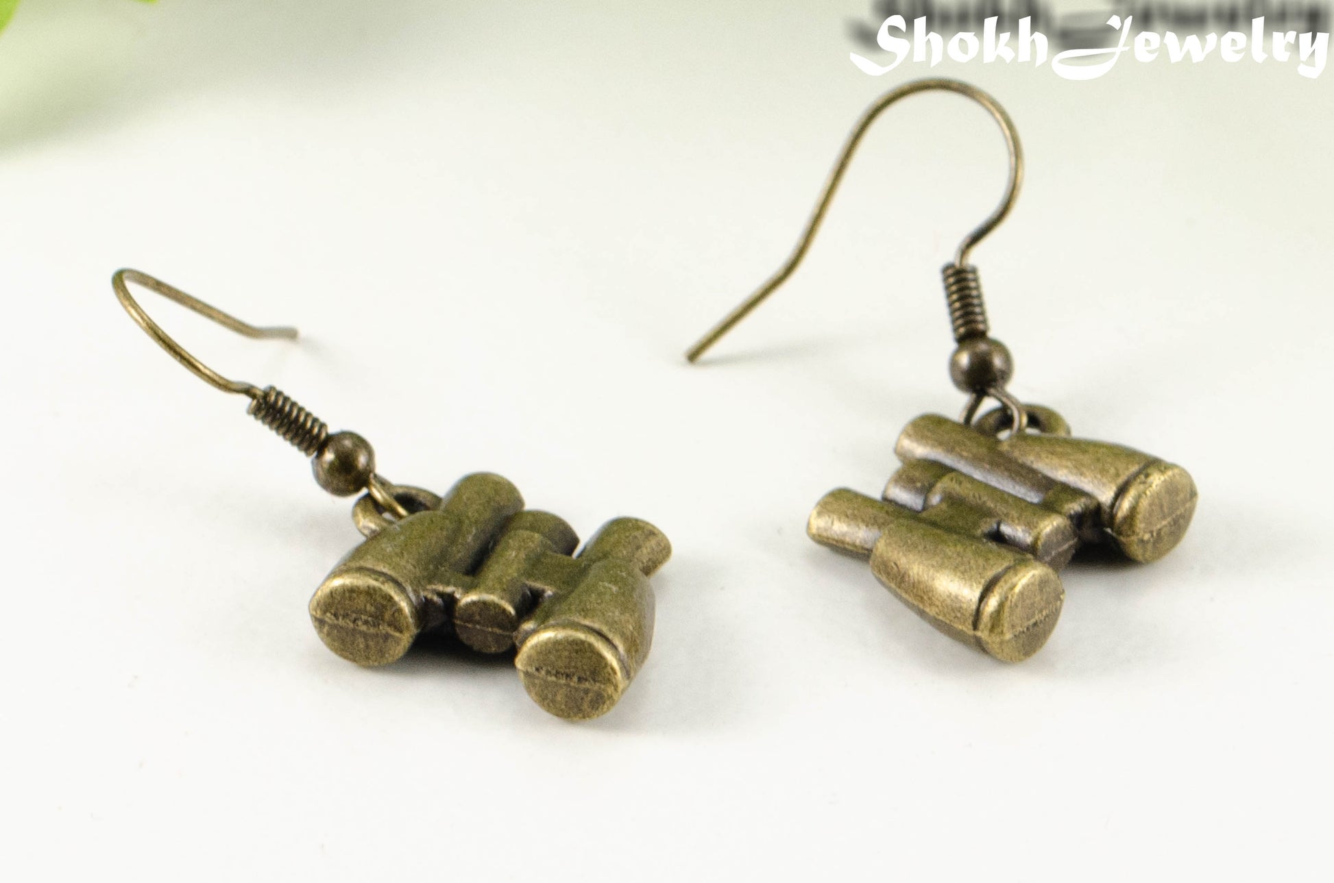 Close up of Antique Bronze Binocular Charm Earrings.