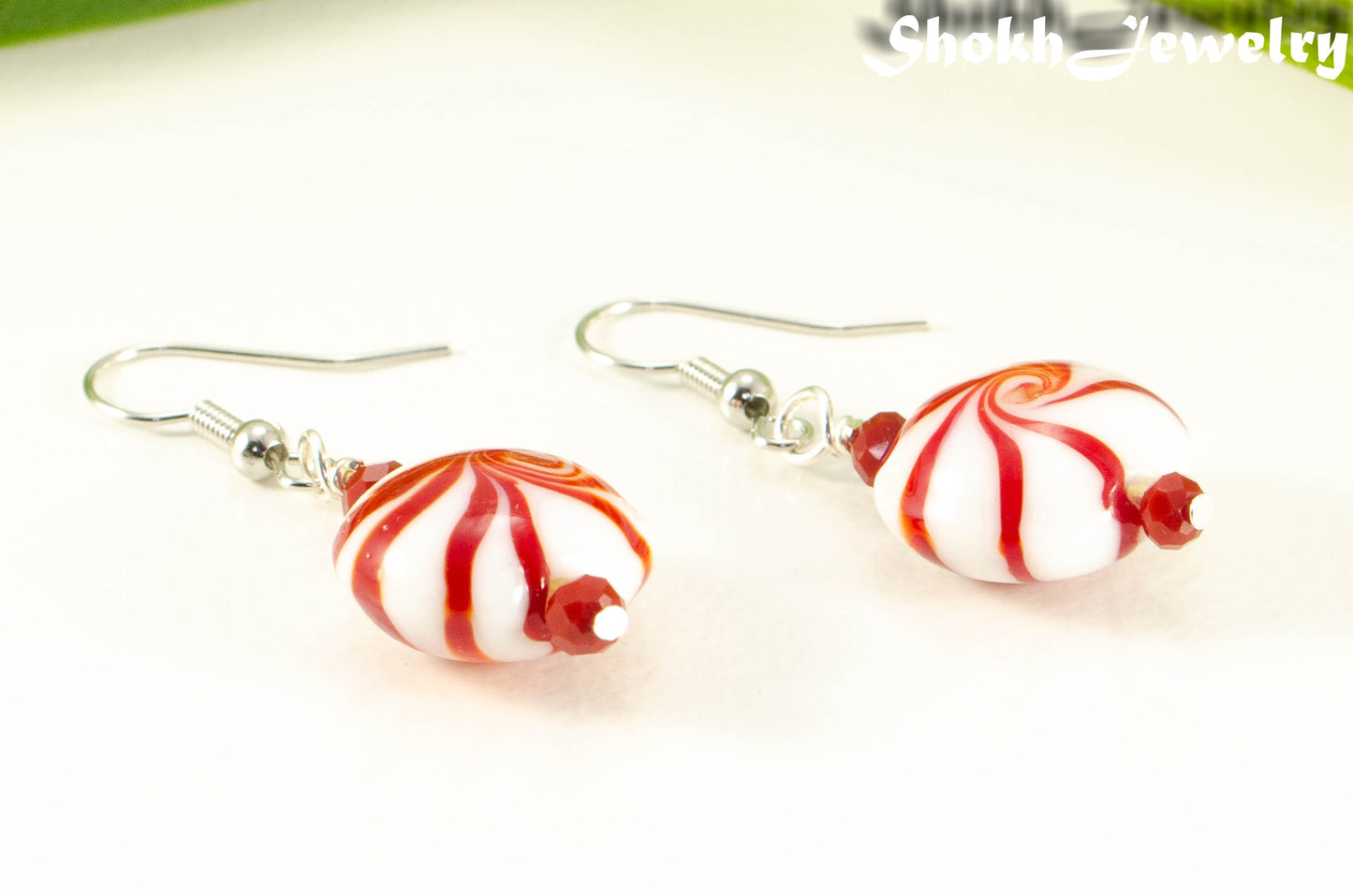 Close up of Christmas Peppermint Glass Bead Earrings.