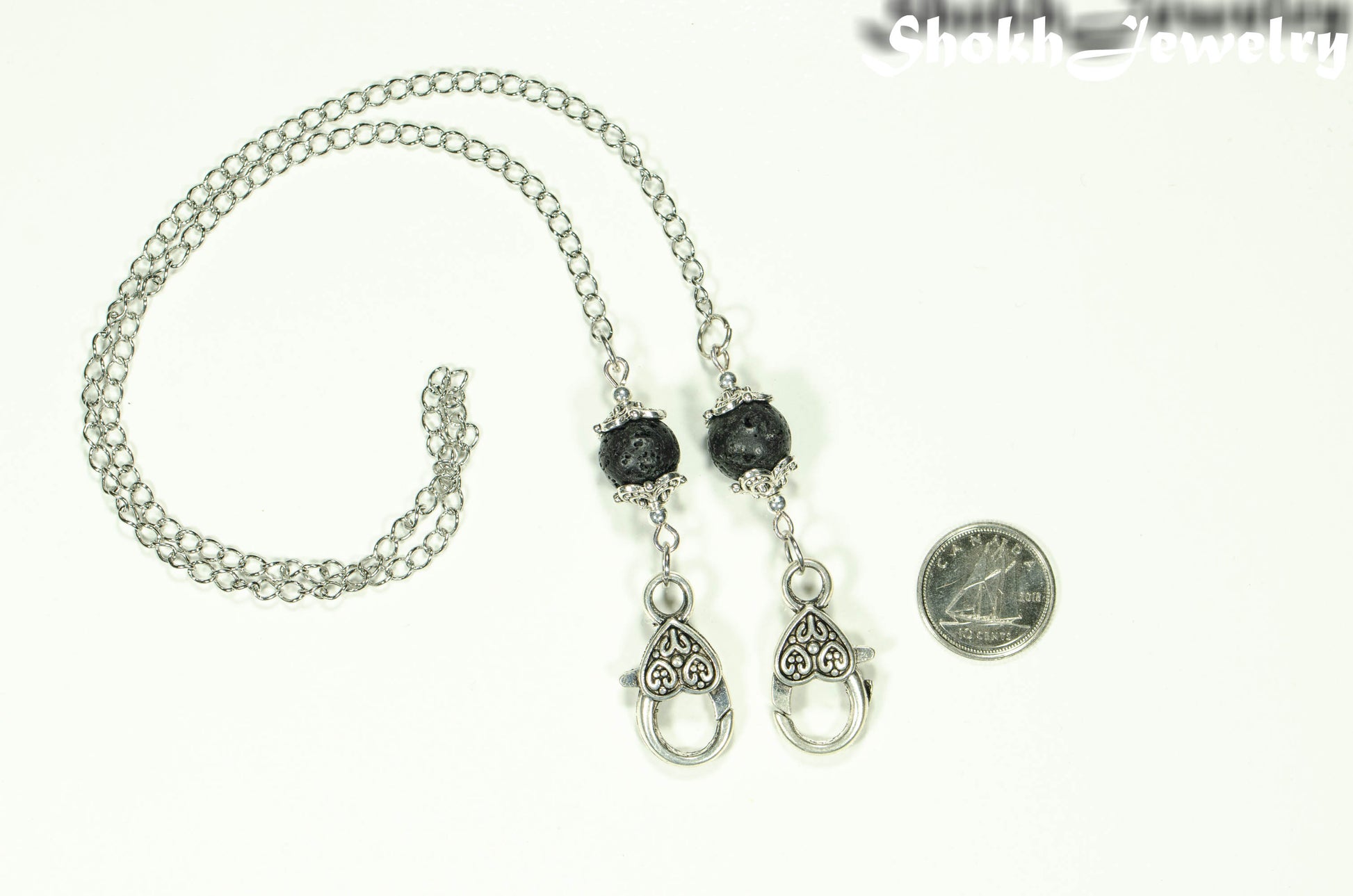 Black Lava Stone Eyeglass chain/Face Mask Lanyard beside a dime.