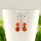 Close up of Small Matte Red Agate Earrings.