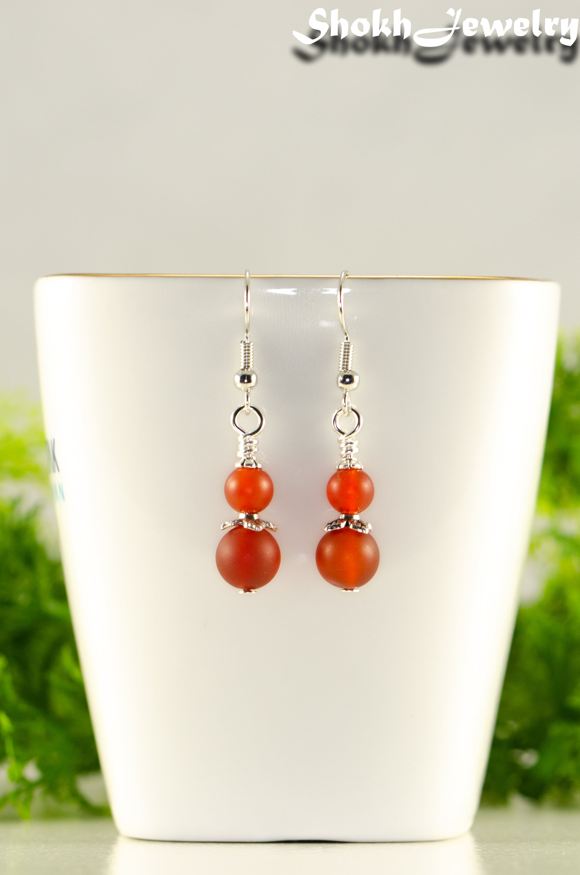 Close up of Small Matte Red Agate Earrings.