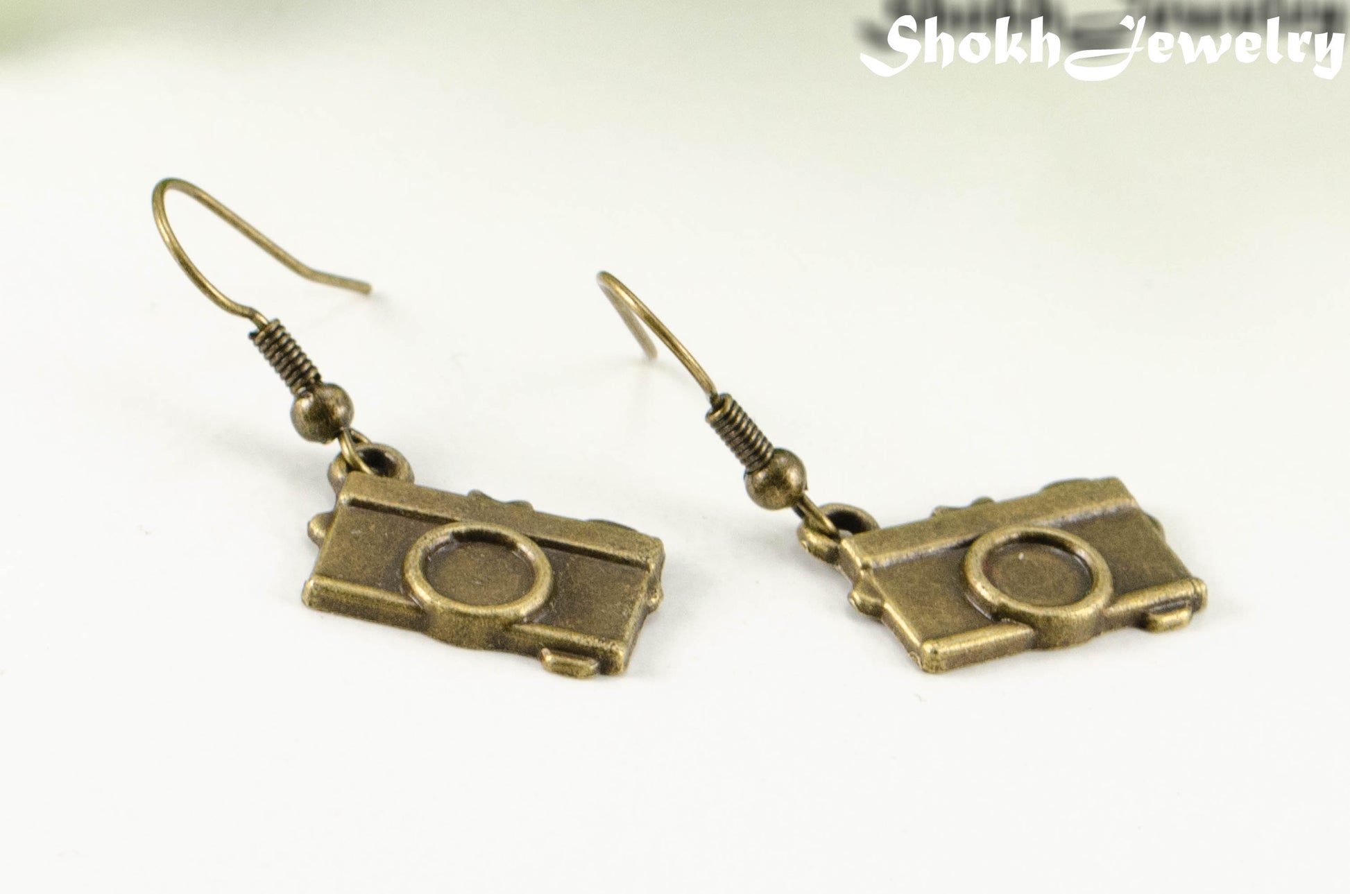 Close up of Antique Bronze Camera Charm Earrings.