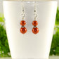 Small Natural Red Jasper Earrings displayed on a tea cup.