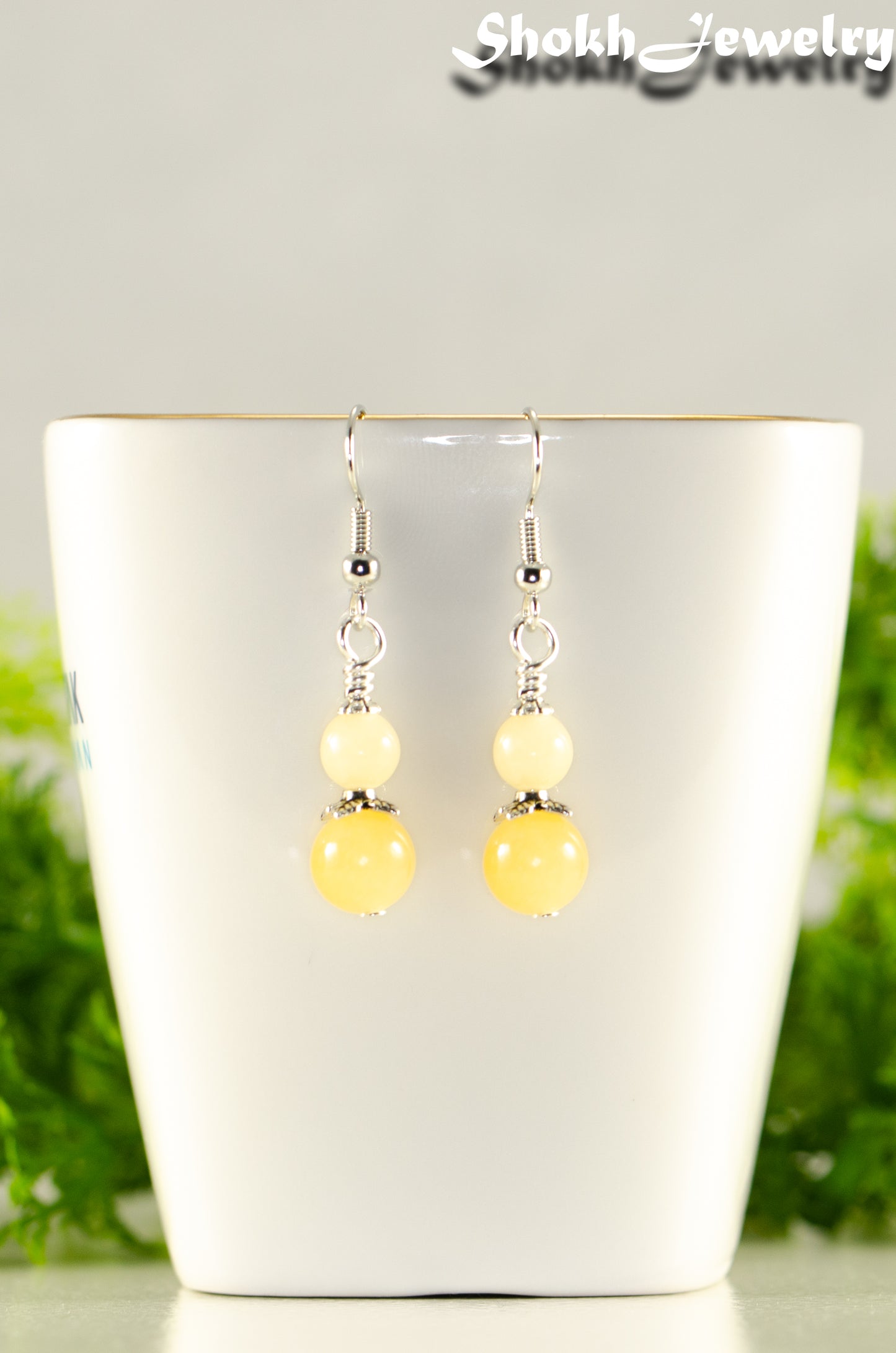 Close up of Small Natural Calcite Crystal Earrings.