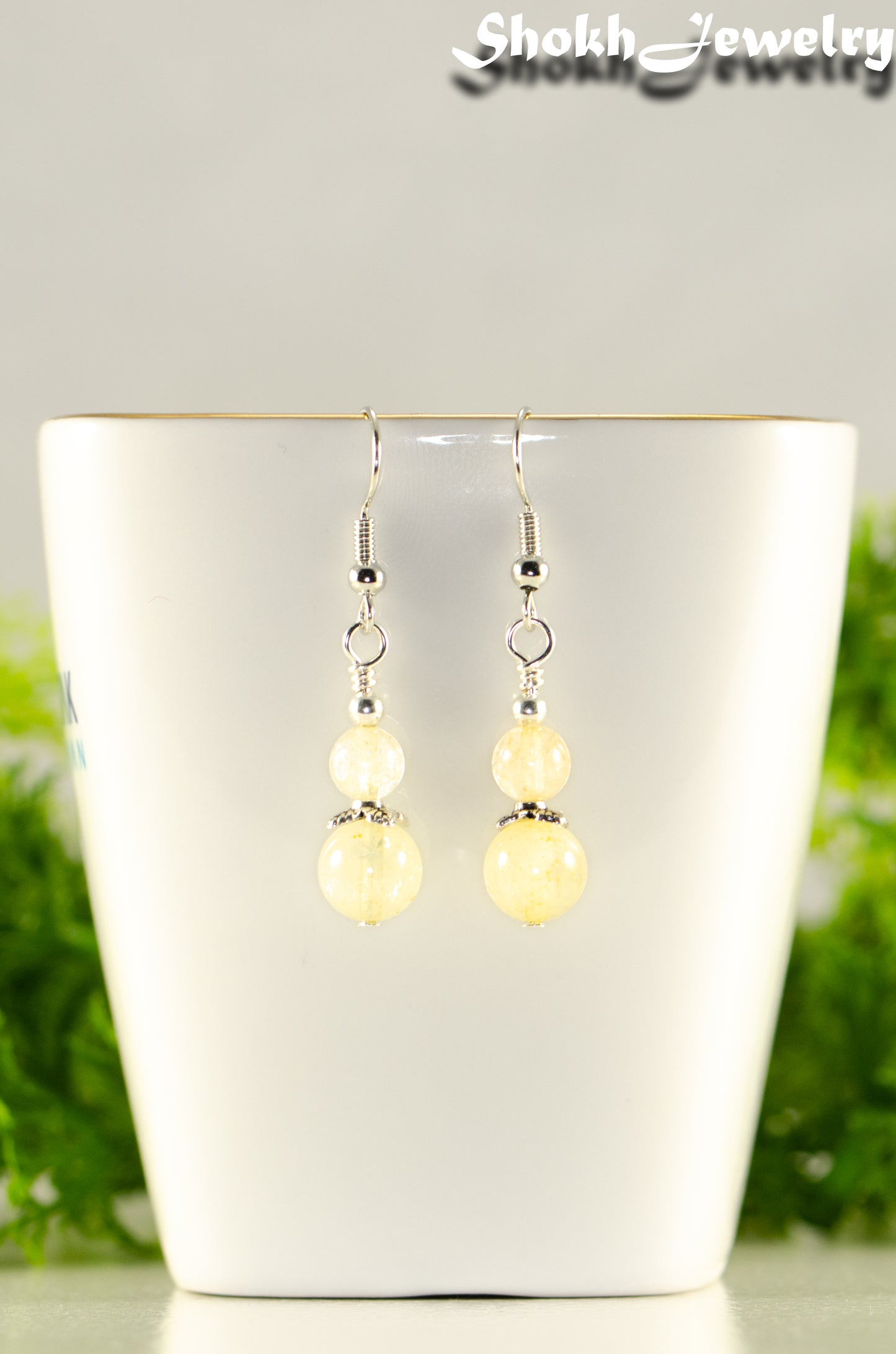 Close up of Small Natural Citrine Crystal Earrings.