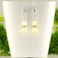 Small Natural Citrine Crystal Earrings displaed on a tea cup.