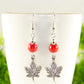 Close up of Red Howlite and Tibetan Silver Maple Leaf Dangle Earrings.