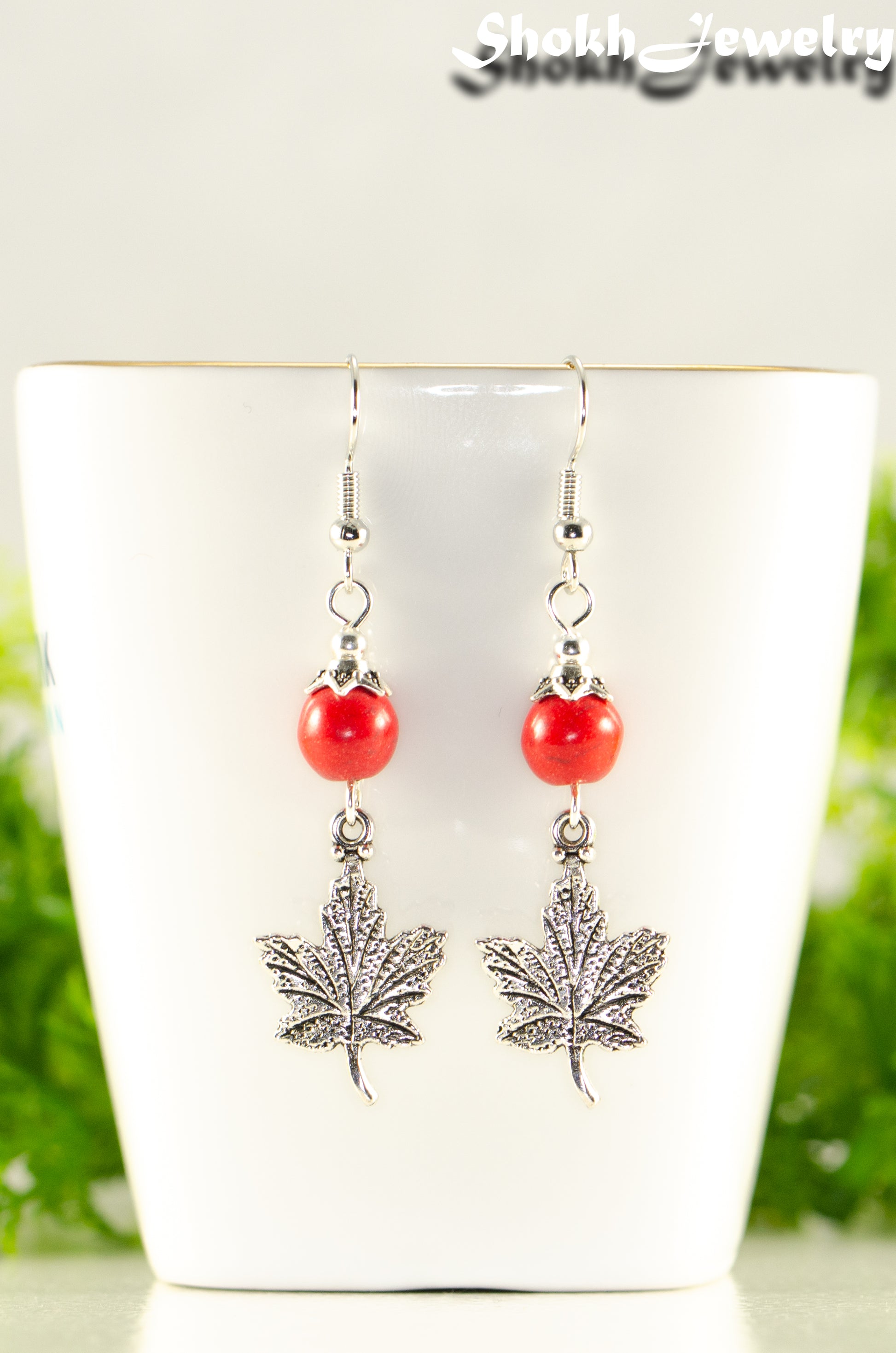 Close up of Red Howlite and Tibetan Silver Maple Leaf Dangle Earrings.