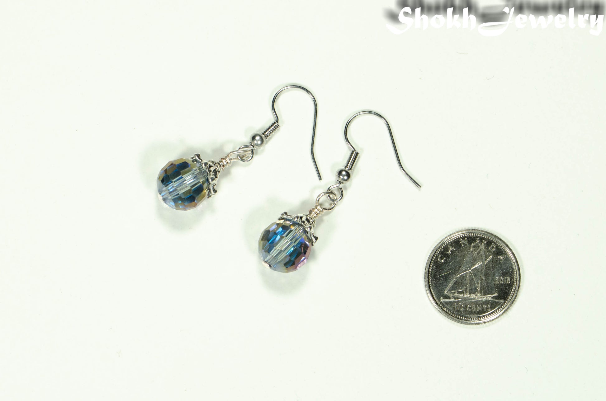 10mm Glass Crystal Disco Ball Earrings beside a dime.
