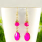 Close up of Hot Pink Oval Glass Dangle Earrings.