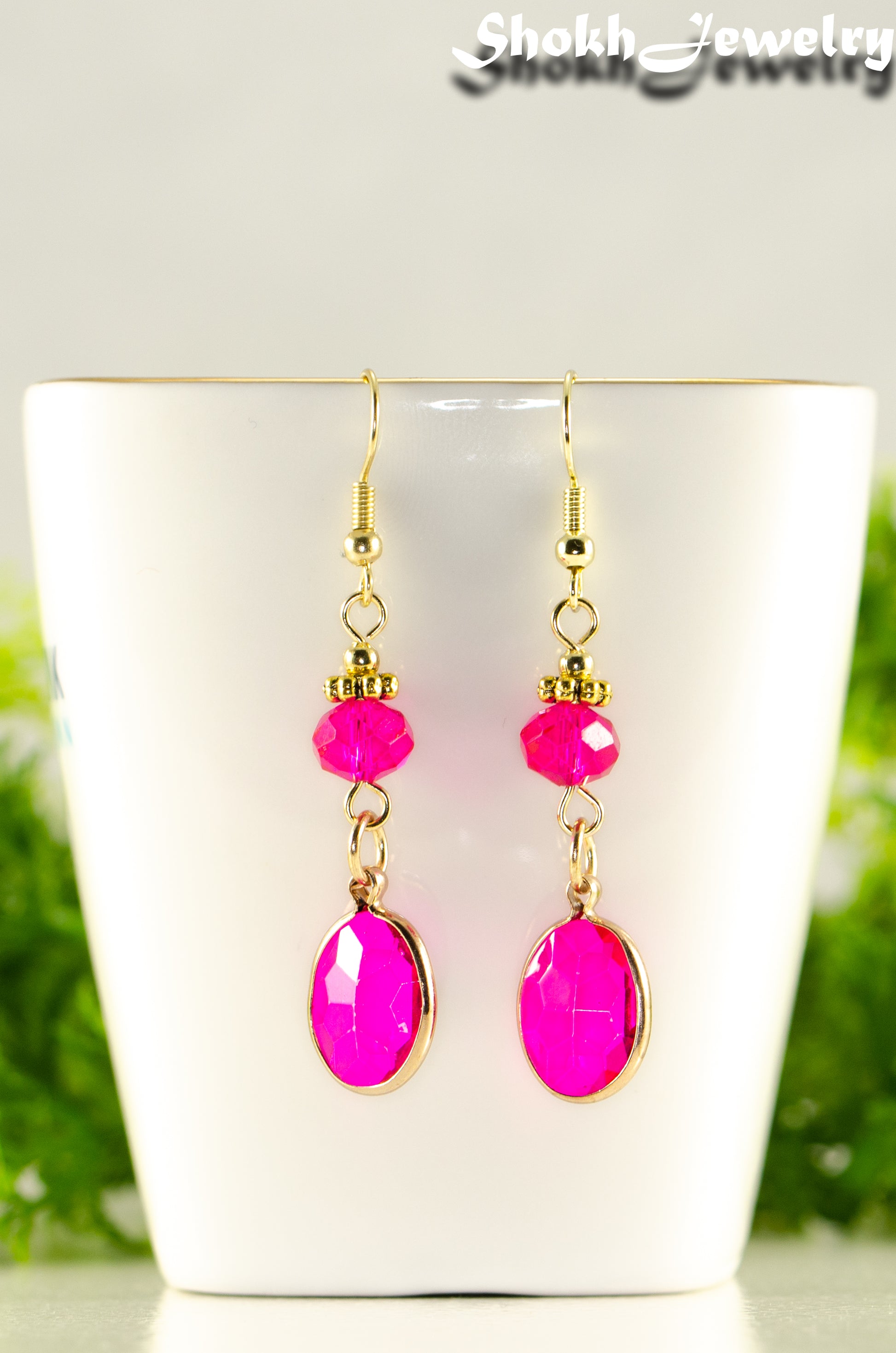 Close up of Hot Pink Oval Glass Dangle Earrings.