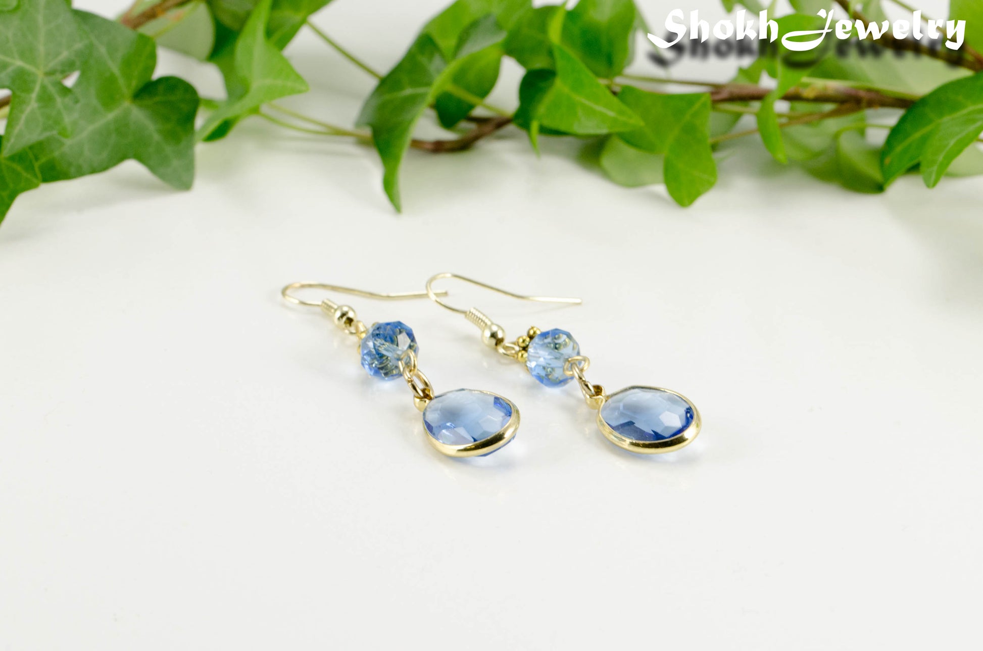 Light Blue Oval Glass Dangle Earrings with gold tone ear wires.