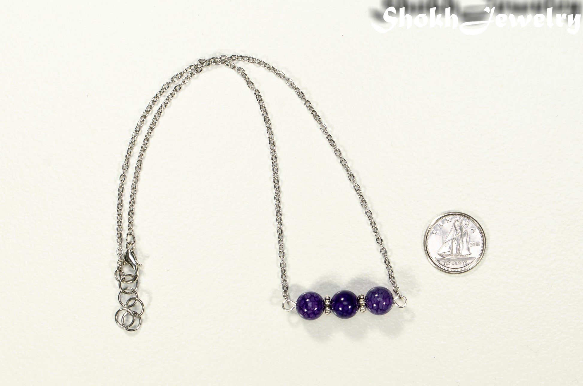 Purple Agate and Dainty Chain Choker Necklace beside a dime.
