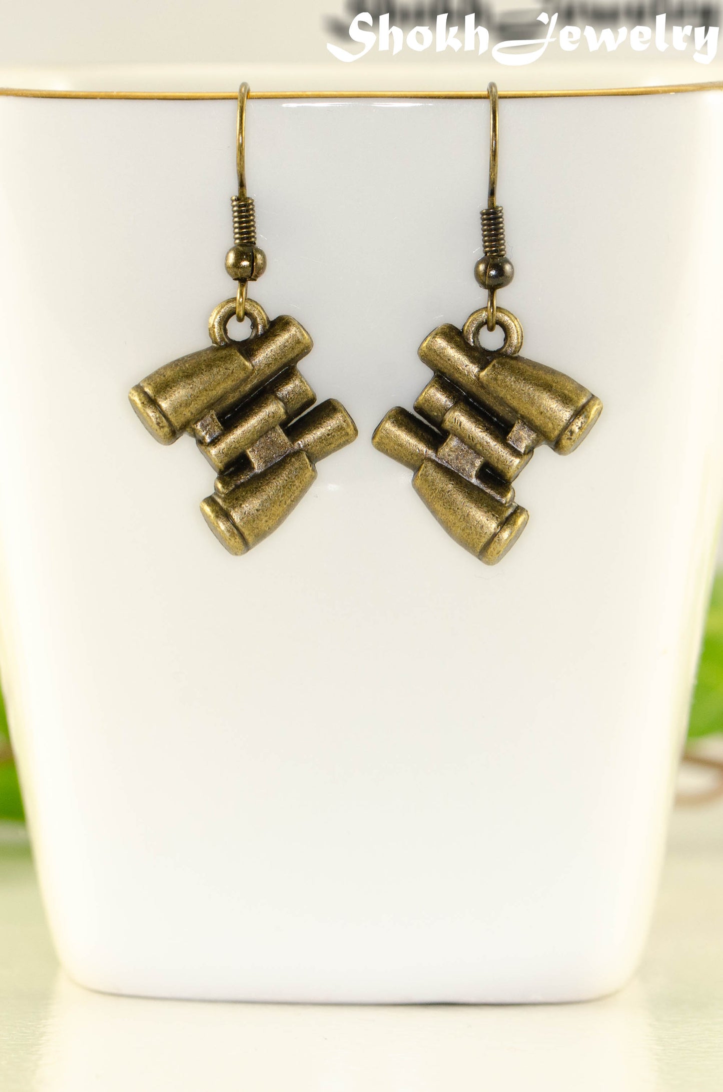 Close up of Antique Bronze Binocular Charm Earrings.