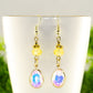 Close up of Light Yellow Oval Glass Dangle Earrings.