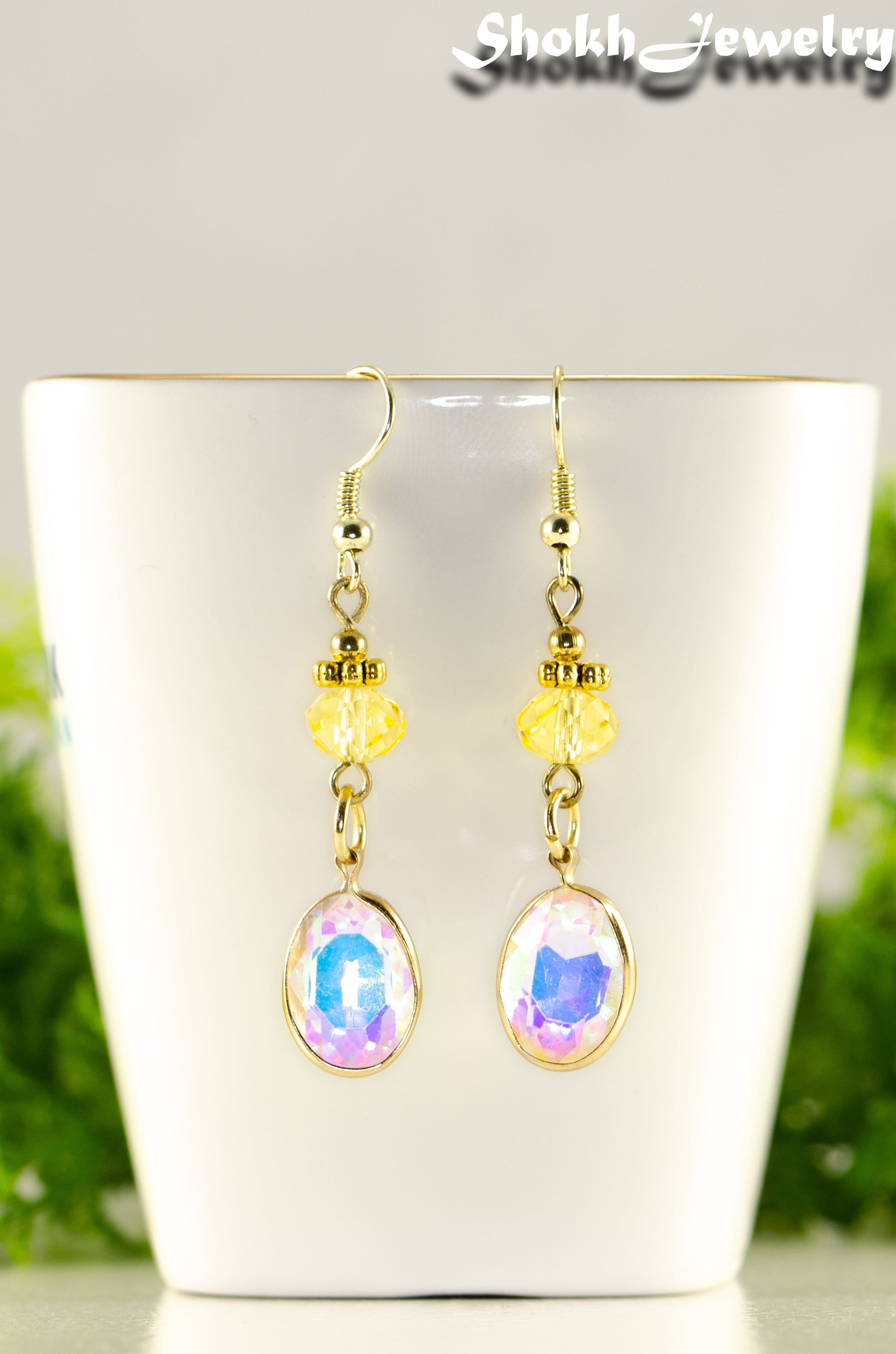 Close up of Light Yellow Oval Glass Dangle Earrings.