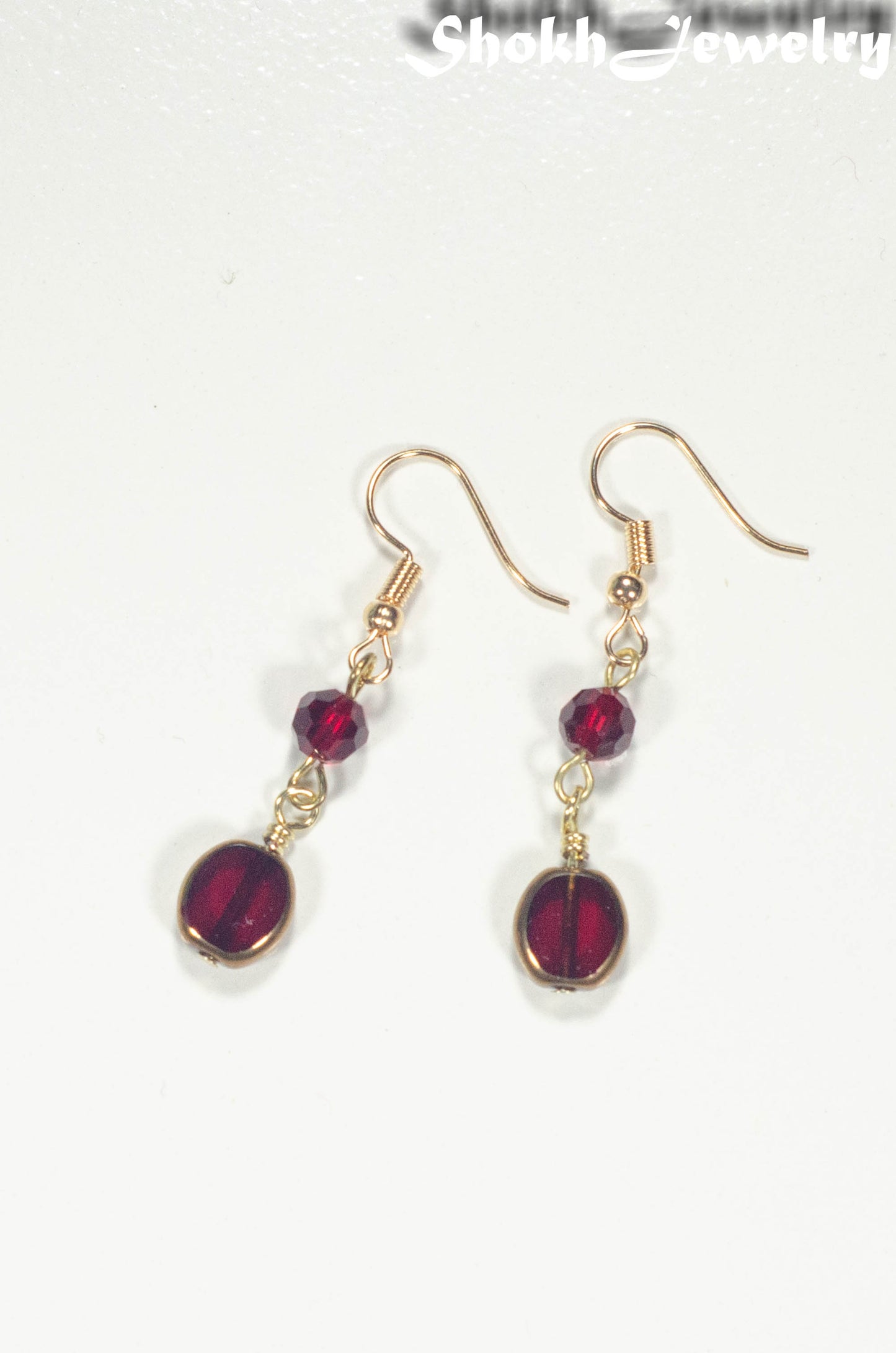 Top view of Dark Red and Gold Glass Bead Earrings.