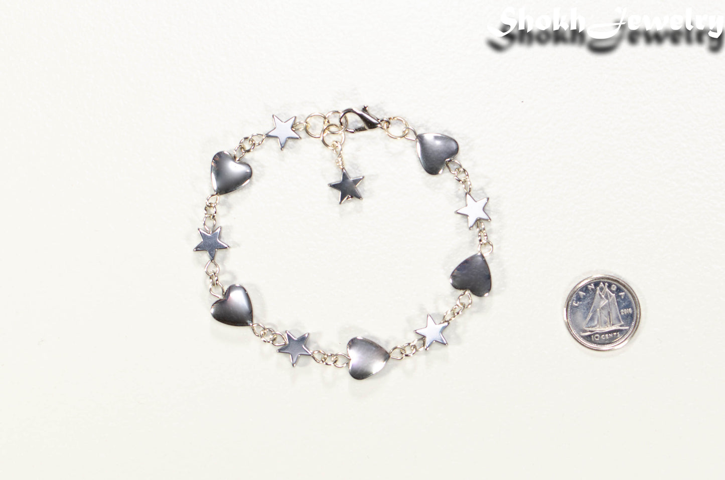 Handmade Hematite Heart and Star Link Bracelet beside a dime.