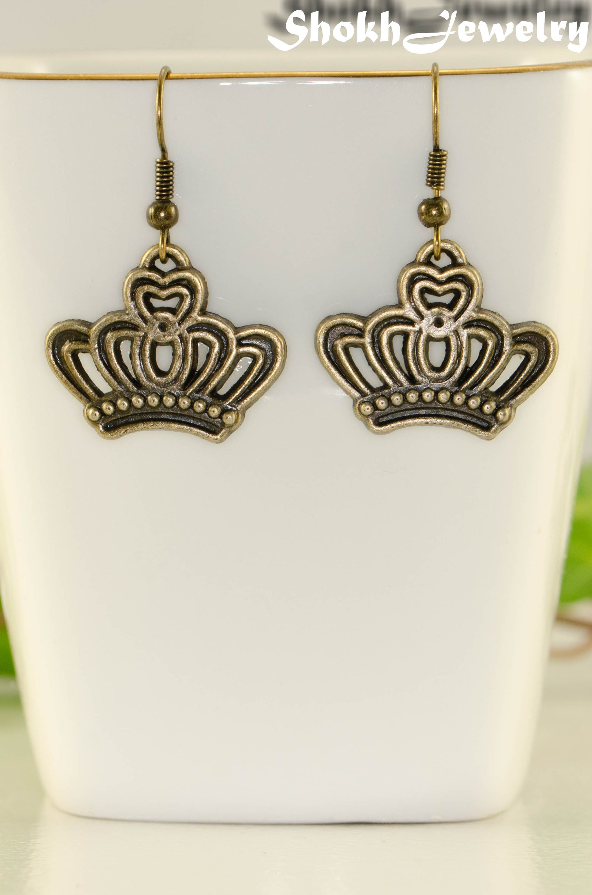 Close up of Antique Bronze Crown Charm Earrings.