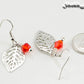 Filigree Silver Leaf Charm and Red Glass Crystal Earrings beside a dime.