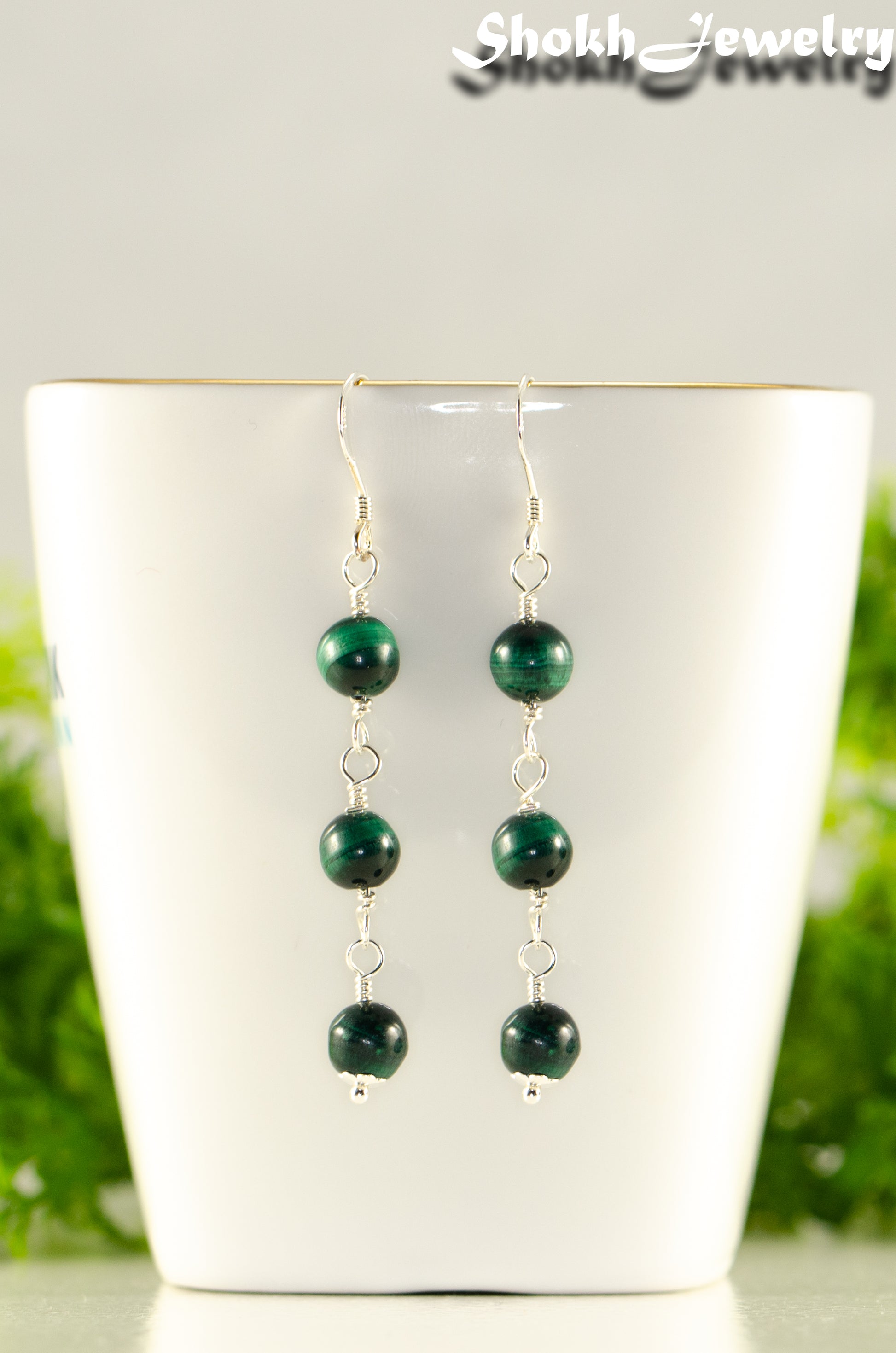 Close up of Long Genuine Malachite Dangle Earrings.