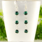 Long Genuine Malachite Dangle Earrings displayed on a tea cup.