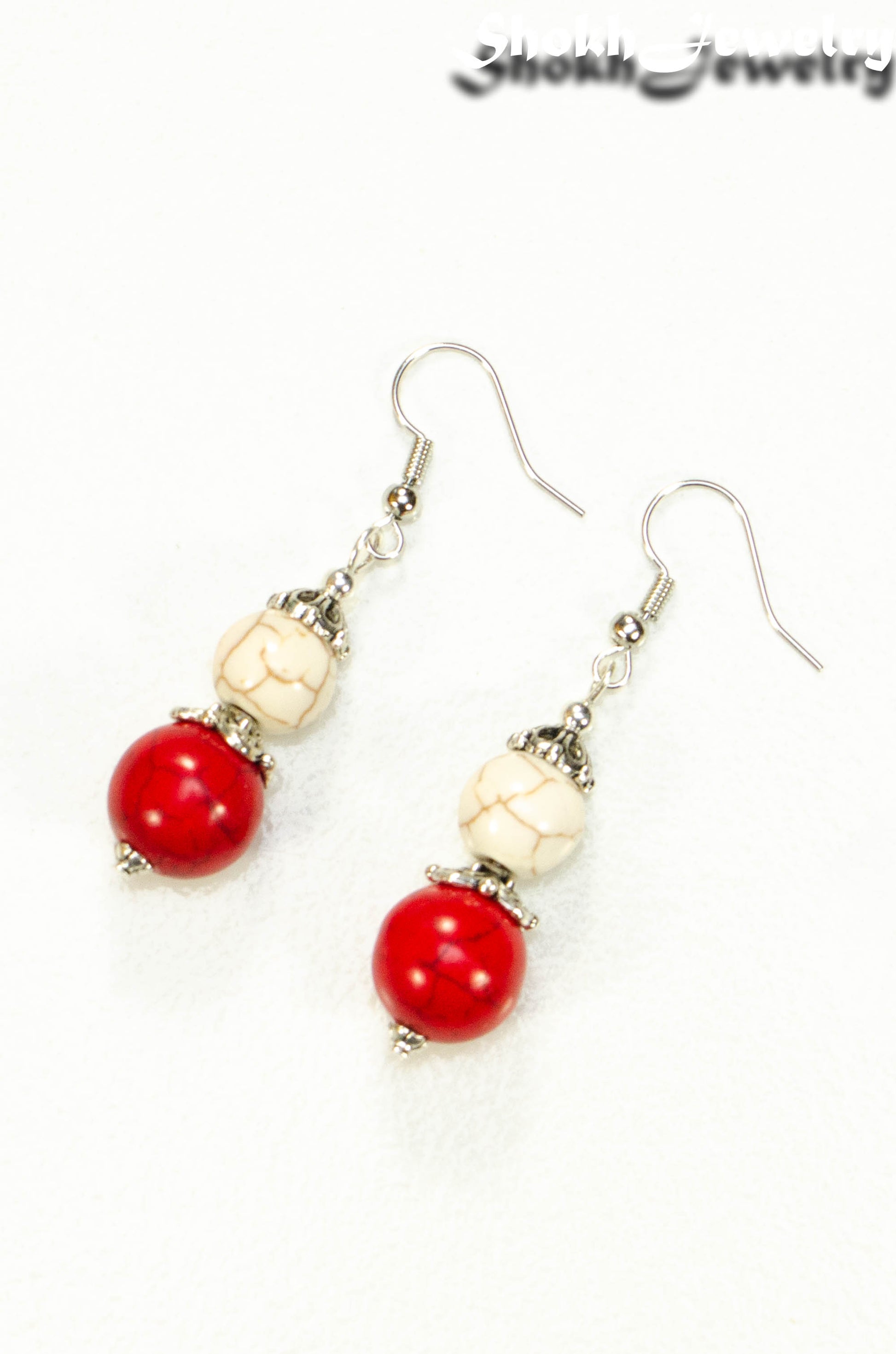 Top view of Red and White Howlite Dangle Earrings.