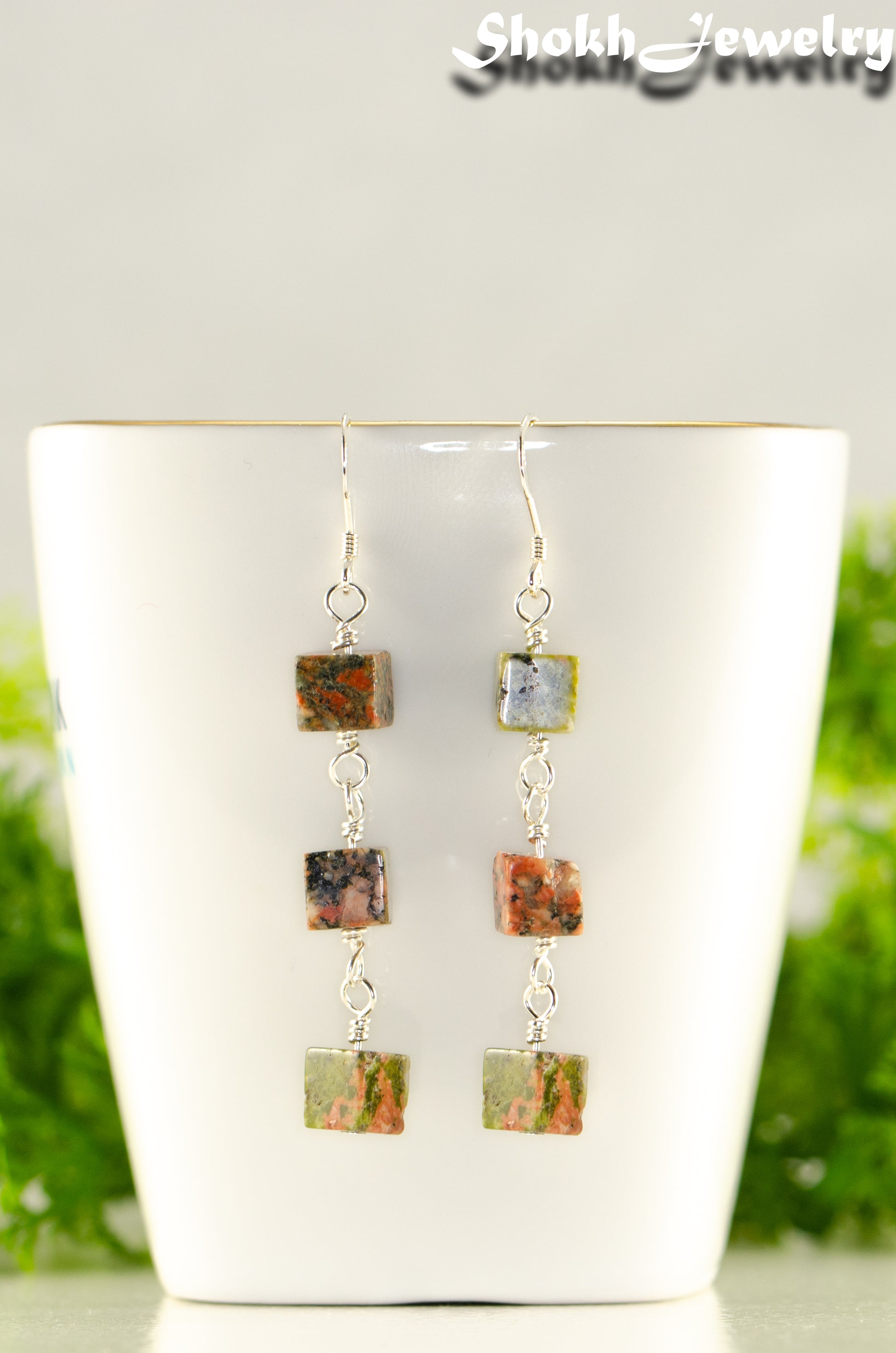 Close up of Long Unakite Cube Dangle Earrings.