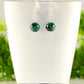 Small Genuine Malachite Drop Earrings displayed on a tea cup.