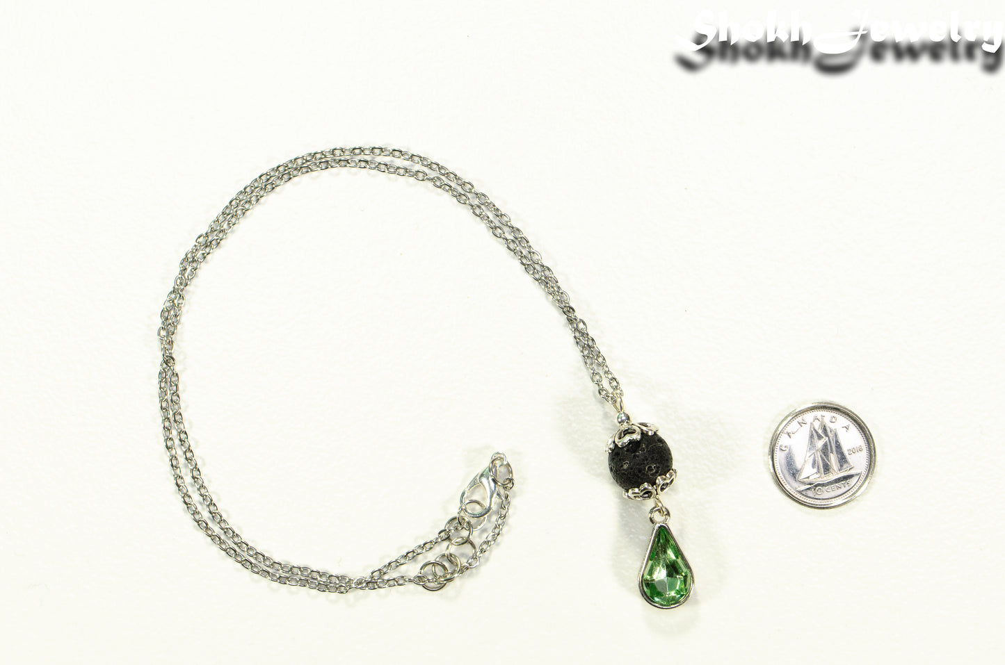 Lava Rock and Teardrop August Birthstone Choker Necklace beside a dime.