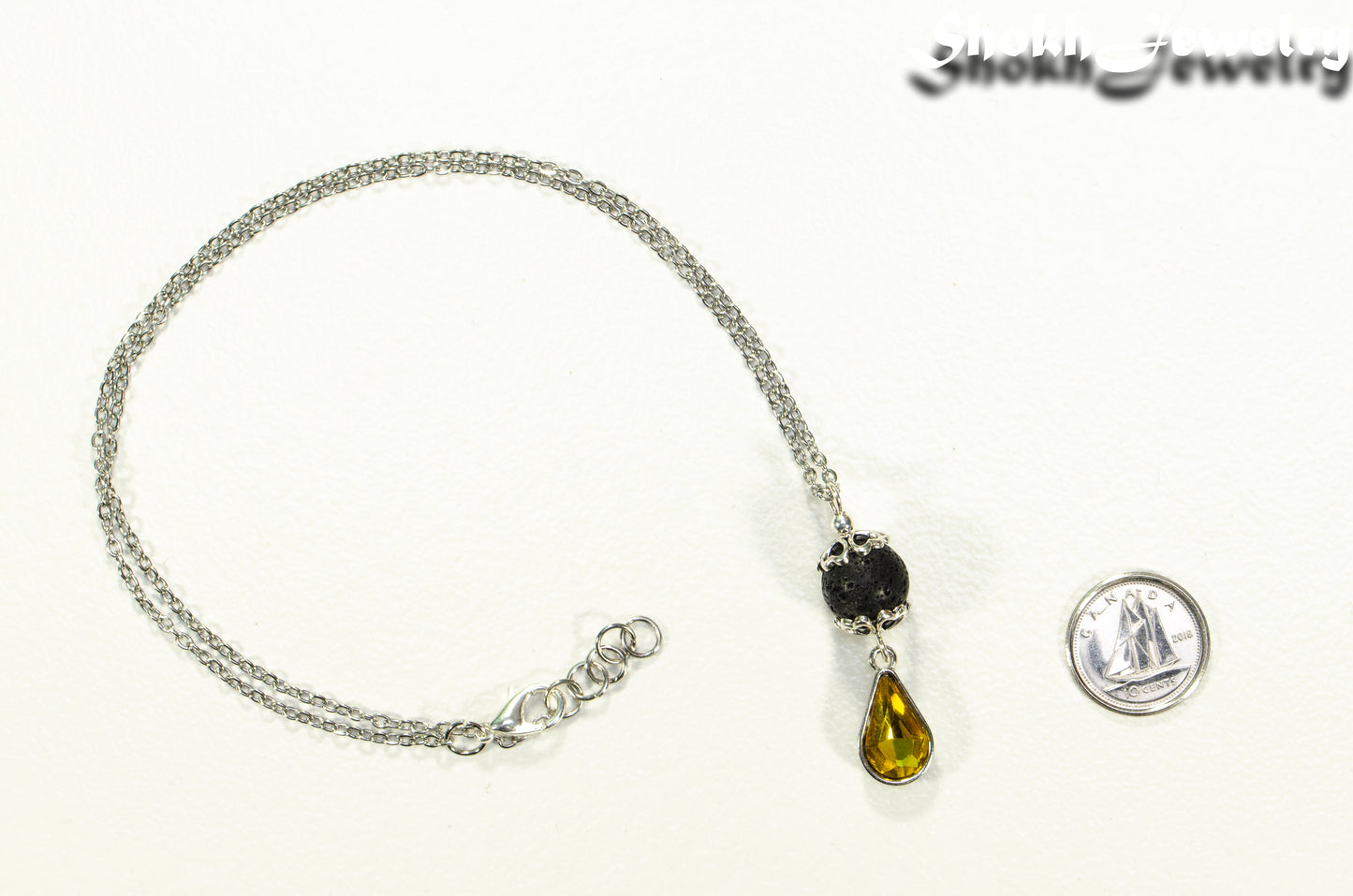 Lava Rock and Teardrop November Birthstone Choker Necklace beside a dime.