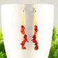 Close up of Long Gold Plated Chain and Red Dyed Bamboo Coral Chip Earrings.