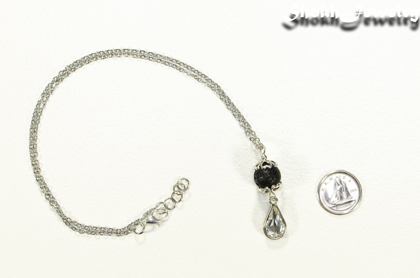 Lava Rock and Teardrop April Birthstone Choker Necklace beside a dime.