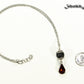 Lava Rock and Teardrop January Birthstone Choker Necklace beside a dime.