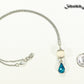 Lava Rock and Teardrop March Birthstone Choker Necklace beside a dime.