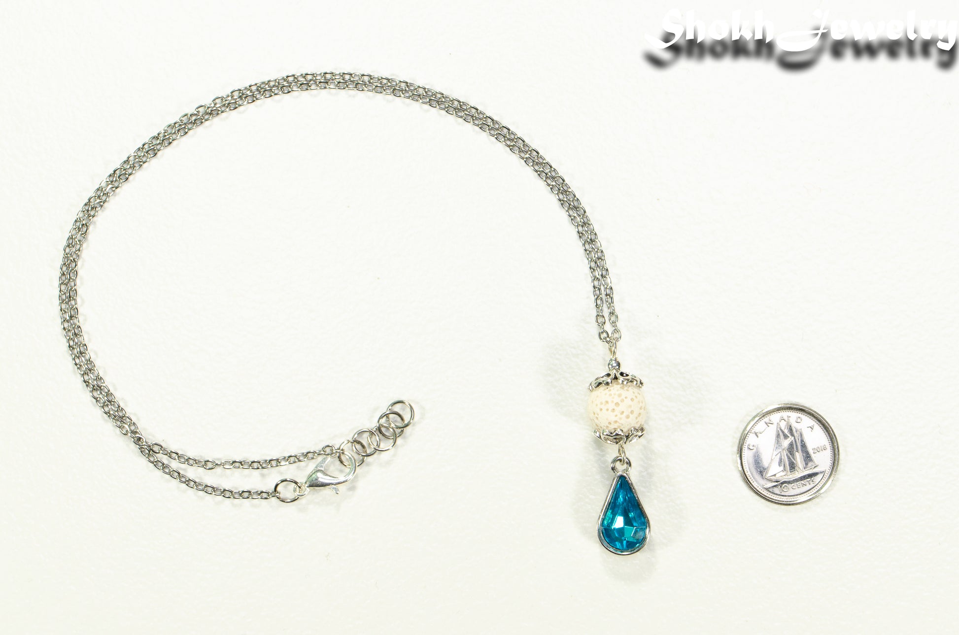 Lava Rock and Teardrop March Birthstone Choker Necklace beside a dime.